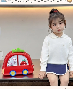 Toddler model wearing a red car-shaped EVA hardshell backpack with cute rabbit graphics