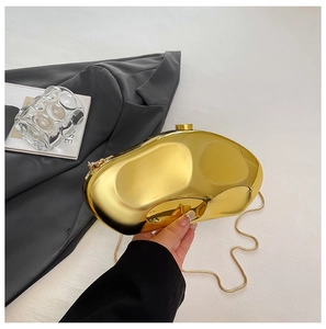 Polished gold geometric acrylic clutch with metal chain strap held for dinner styling