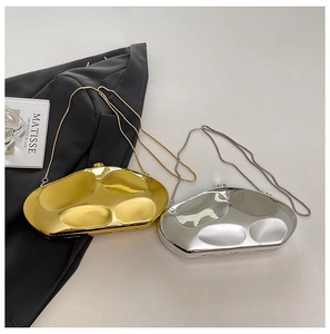 Detailed view of silver and gold liquid metal clutch bags with slim snake chains