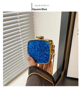 Detailed close-up of blue sequin party clutch with gold metal frame and clasp