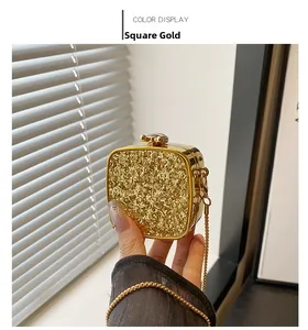 Detailed close-up of square gold sequin evening bag with metallic trim and chain strap