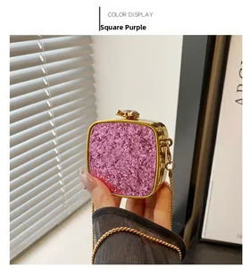 Detail of square purple sequin mini bag with gold chain strap and metallic lock