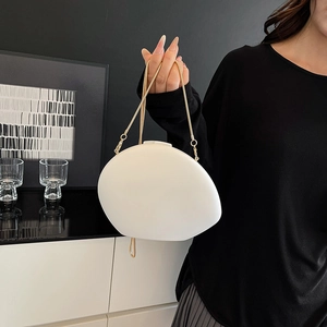 Elegant white pebble-shaped acrylic clutch bag with a fine gold chain shoulder strap