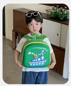 Kid's green EVA eggshell backpack featuring 3D cartoon ship design and yellow zippers