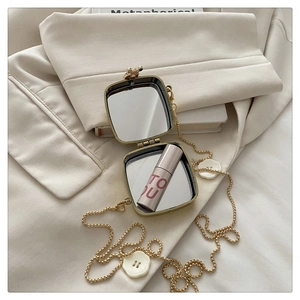 Mini gold metal makeup mirror case with dual interior mirrors and a thin ball chain strap