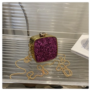 Detail of purple sequin mini evening bag with gold metal frame and chain strap