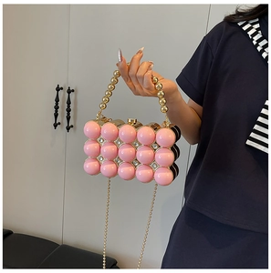 Detail of pink pearl beaded acrylic evening bag with gold chain and handle