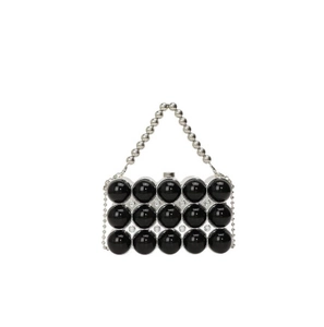 Detail of black beads and sparkling rhinestones on an acrylic evening clutch bag