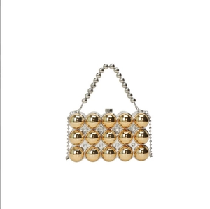Detail of evening bag with golden mirror spheres and silver beaded handle decorations