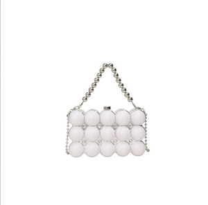 Close-up of white beaded evening bag with silver metal trim and elegant beaded handle