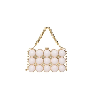 Detailed close-up of white resin pearls and gold metallic frame on an elegant evening bag