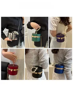 Detailed view of fashionable acrylic cylinder evening bags in six assorted colors and gold chains