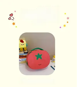 Close-up of cute tomato-shaped nylon makeup bag with star leaf and smiley face detail