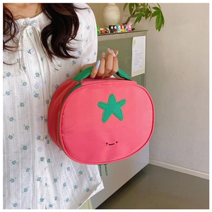 Close-up of pink nylon makeup bag with green star detail and cute smiley embroidery