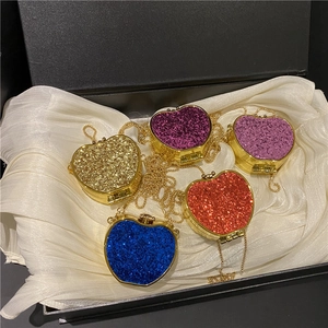 Glittering apple-shaped mini evening bags in five colors with gold chain straps