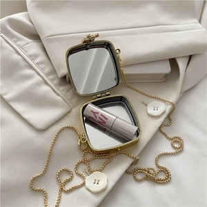 Mini gold acrylic crossbody evening bag with metal finish and built-in vanity mirror