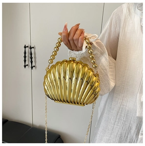Chic shell-shaped gold acrylic clutch with pearl handle and metal chain strap for women