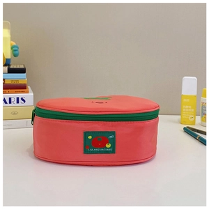 Pink nylon cosmetic bag with green tomato patch and zipper, travel storage pouch