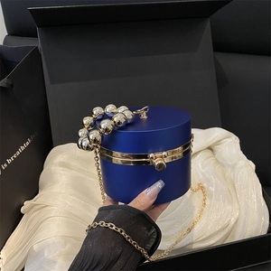 Royal blue cylindrical acrylic evening bag with oversized bead handle and gold chain