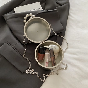 Chic round silver metal hard shell clutch bag with beaded handle and chain strap