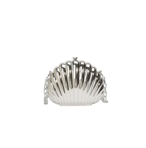 Macro detail of silver shell evening bag showing radial texture and metal clasp