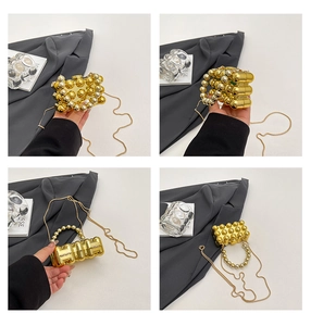 Detail view of gold beaded acrylic mini evening clutch bag with pearl handle and chain