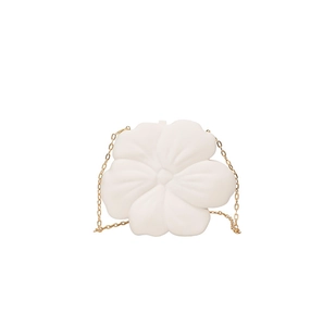 Detailed close-up of white 3D petal-shaped bag with delicate gold chain strap