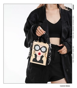 Close-up of pop art crossbody bag with sunglasses portrait and silk scarf handle