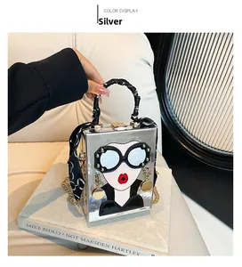 Silver square box handbag with cartoon sunglasses face and silk scarf wrapped handle