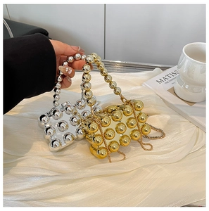 Close-up of gold and silver mini beaded evening bags with metallic chains and handles