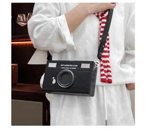 Detail of camera-shaped crossbody bag with lens decor and Influencer Cam print