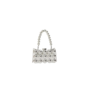 Detail view of a silver acrylic evening bag with spherical textures and beaded handle