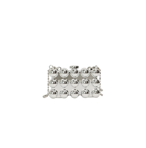 Detail view of silver acrylic clutch featuring 15 metallic spheres and thin bead chain strap