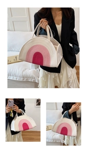 Detail of a semi-circular cotton rope woven handbag with pink rainbow pattern and dual handles