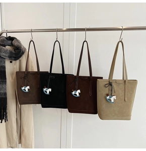 Detail view of large tote bags in four colors with cute wooden horse charms