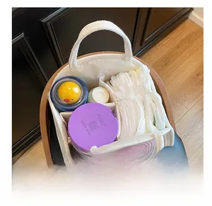 Top view of white cotton rope diaper caddy with dividers showing internal storage capacity