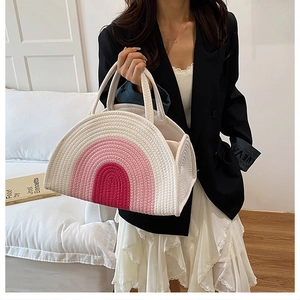 Close-up of a woven cotton rope tote bag featuring a vibrant pink rainbow pattern