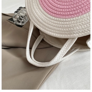 Detailed close-up of woven cotton rope diaper bag showing pink and white spiral texture