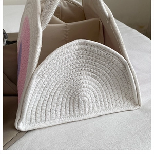 Close-up of cotton rope diaper caddy showing woven rainbow design and inner dividers