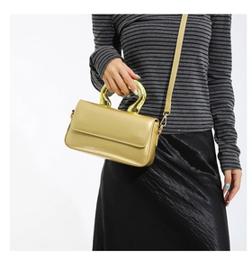 Model view of yellow PU leather envelope bag with metallic U-shaped handle and strap