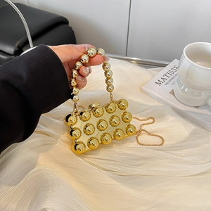 Gold acrylic evening clutch with pearl handle and metallic studs for women