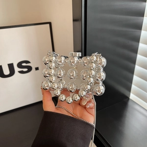 Chic silver evening bag with metallic spherical accents and sleek chain strap for women