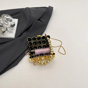 Modern gold mini pearl handle evening bag with textured metallic finish and chain strap