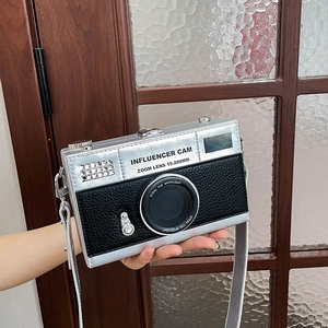 Fashionable camera shaped crossbody bag in silver and black with influencer lettering