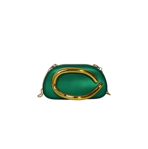 Emerald green acrylic evening bag detail with gold C-handle and fine snake chain