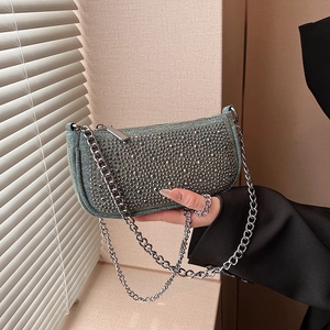 Chic denim baguette bag with silver studs and metal chain strap in Y2K style