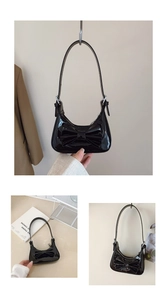 Détail du sac à main en cuir verni noir brillant avec un grand nœud décoratif