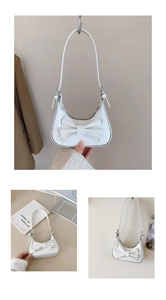 Détails macro du sac à main en cuir verni blanc avec nœud et ferrures argentées
