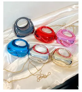 Detail of colorful metallic crescent bags with sleek mirror finish and chain straps
