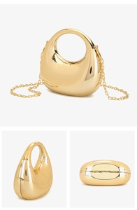 Detailed side view of a crescent-shaped gold acrylic clutch bag with a metallic chain strap